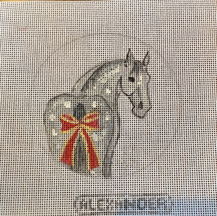 Horse with large red bow on tail