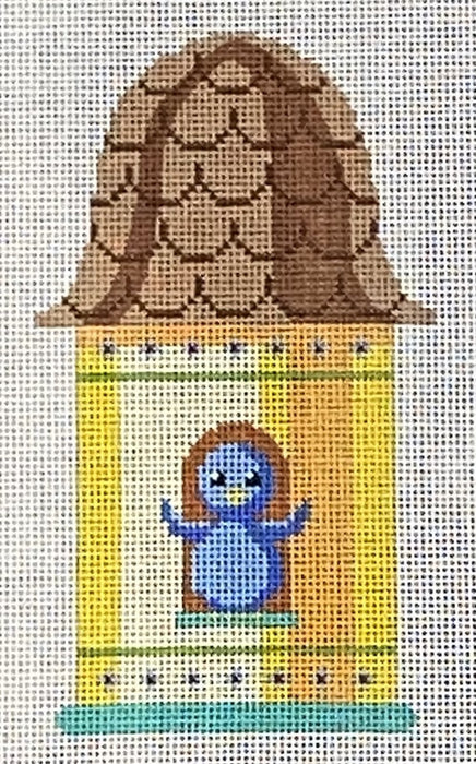 Yellow birdhouse with blue bird