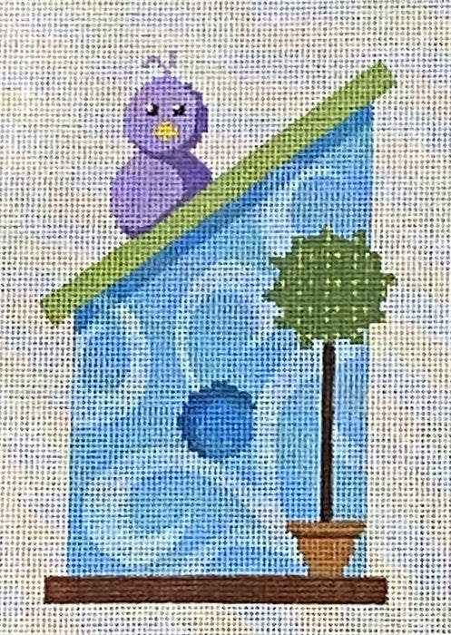 Blue birdhouse with purple bird